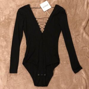 Kittenish black lace up plunge body suit